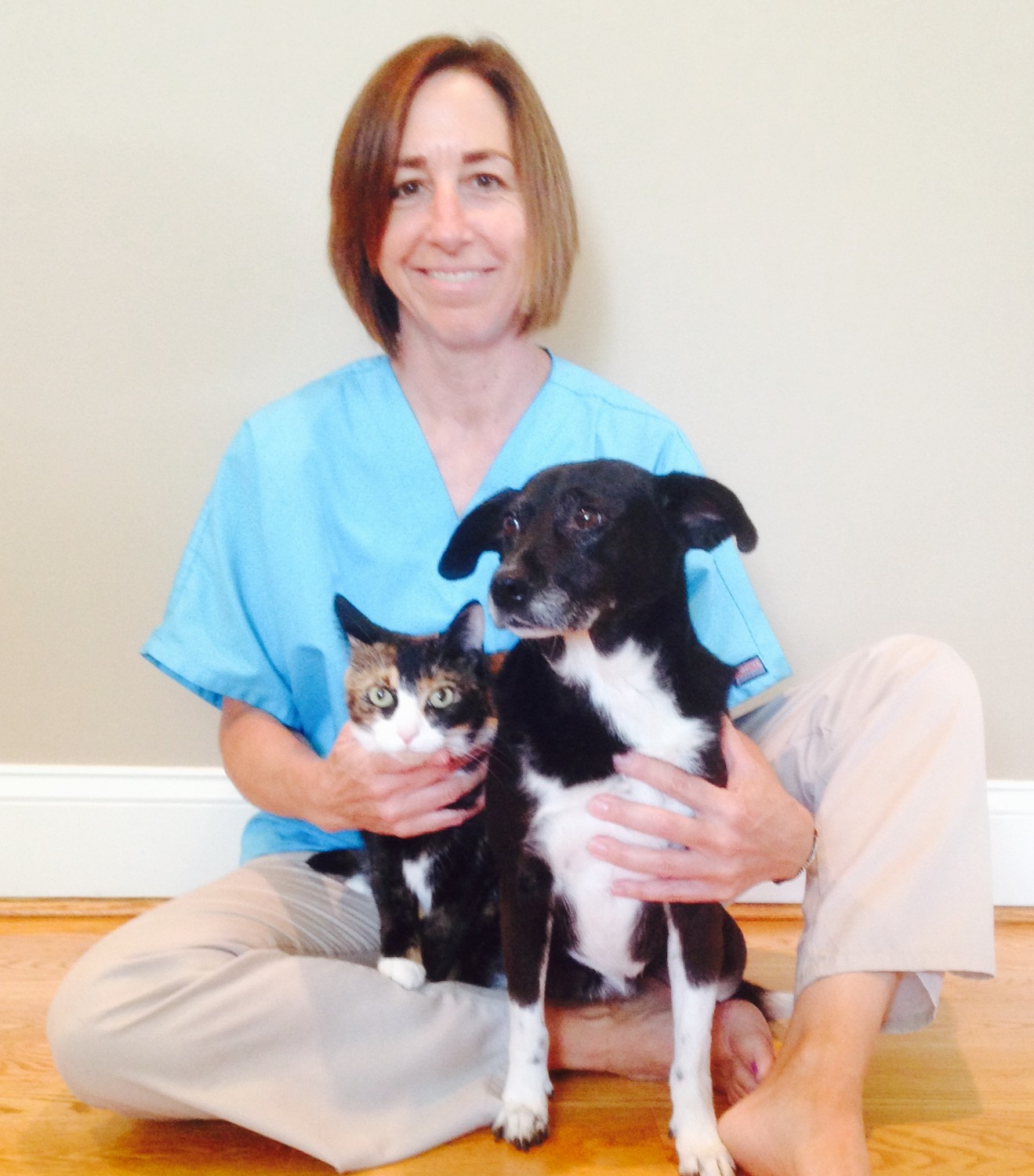 Dr. Peterson's veterinary assistant with her cat and dog